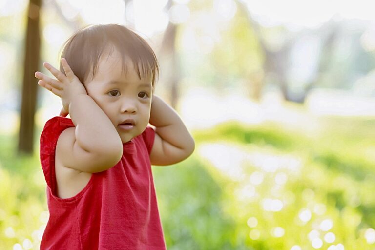 Child covering ears.