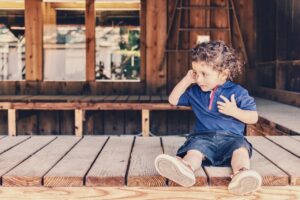 Boy sitting alone and talking to himself.